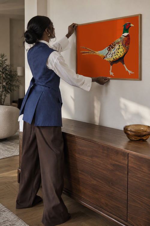 Strutting Pheasant On Orange - Framed poster in an interior