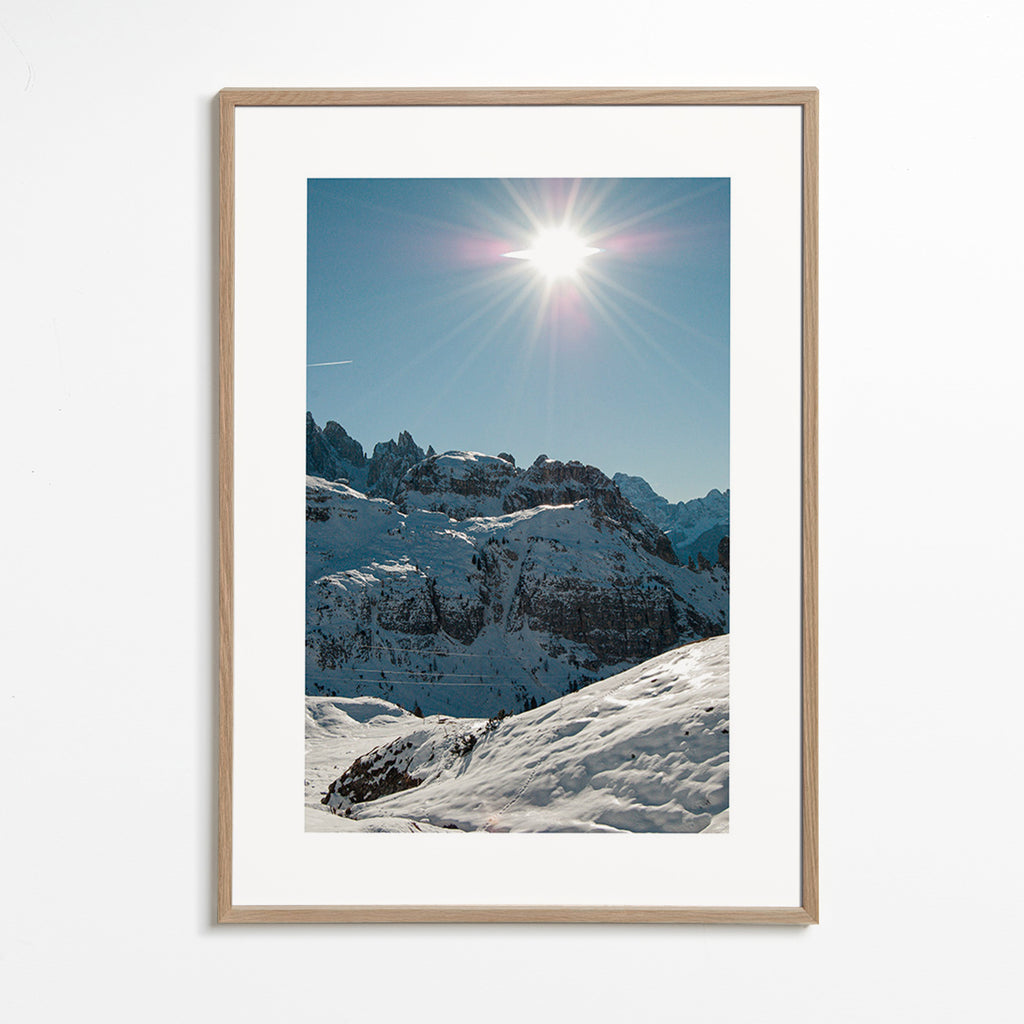Küstenlandschaft: verschneite Gipfel mit strahlender Sonne